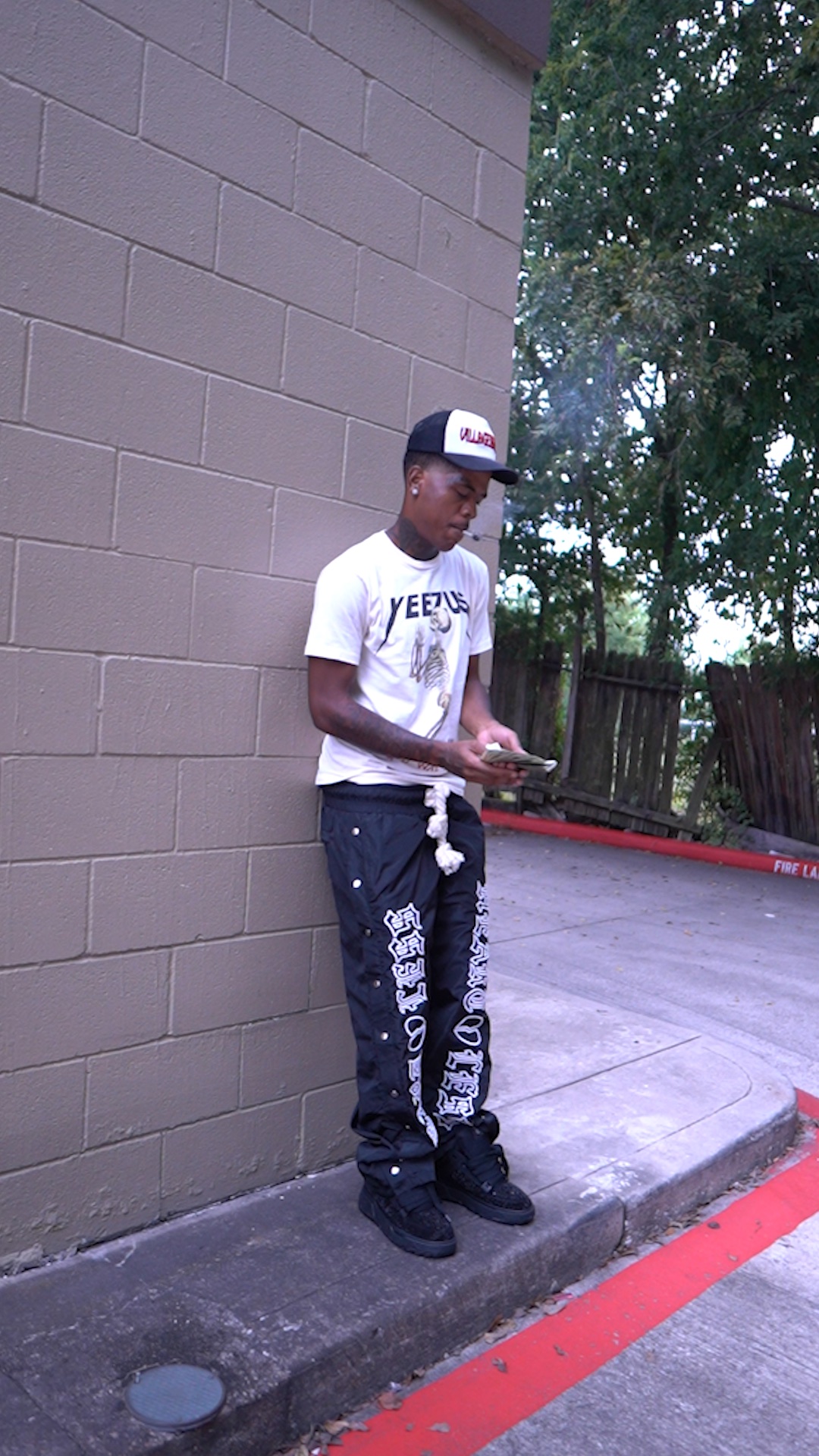 Music video frame of an artist outside